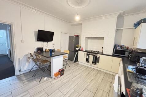 A bright and spacious living room with large wi...