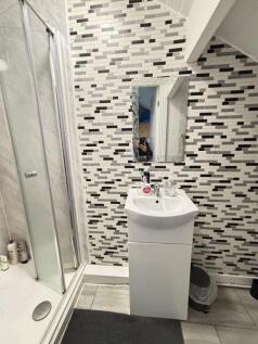 A modern bathroom with a stylish mosaic tile wa...
