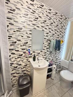 A clean, modern bathroom featuring a stylish mo...