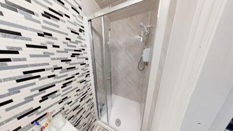 A modern, clean bathroom suite featuring a larg...