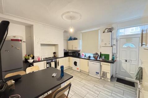 Bright and spacious kitchen area featuring larg...