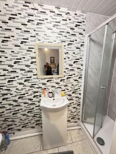 Modern bathroom featuring a stylish patterned w...