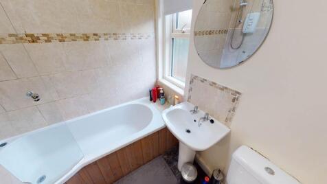 A clean and functional bathroom featuring a bat...