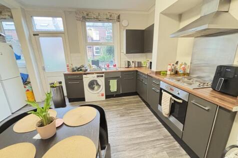 Bright and modern kitchen featuring ample count...