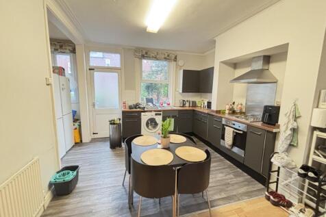 A modern, well-lit kitchen featuring ample coun...