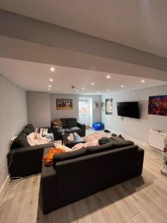 A spacious and modern living room featuring con...