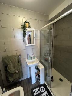 A clean and modern bathroom featuring a shower ...