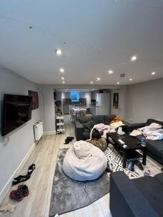 A spacious and modern living room featuring a l...