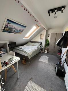 A cozy bedroom featuring a double bed and a sty...