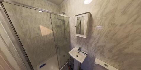 A clean and functional bathroom with a large sh...