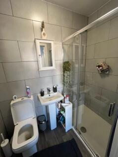 A modern bathroom featuring a walk-in shower, t...