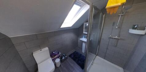 A clean and well-lit bathroom featuring a moder...