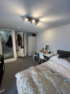 A cozy bedroom featuring a comfortable bed with...