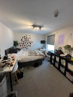 A spacious, well-lit living room featuring seve...