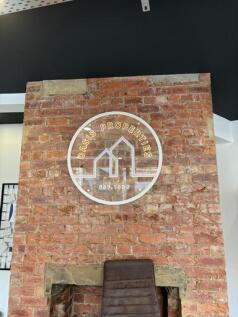 Exposed brick feature wall with mounted circula...