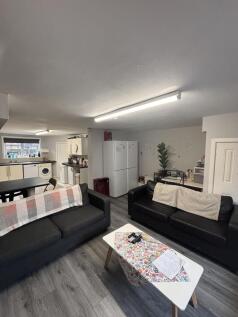 A modern, well-lit living room with comfortable...