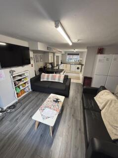 A bright, modern living room featuring comforta...