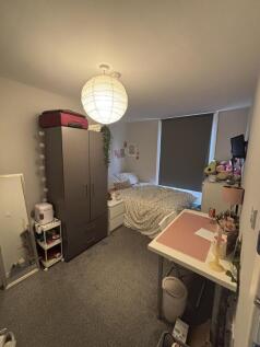 A cozy bedroom featuring a comfortable bed, a w...