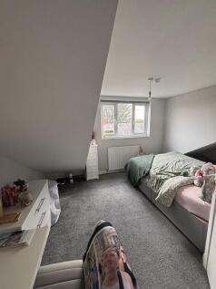 A cozy bedroom with a double bed, soft bedding,...