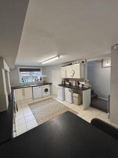A bright, modern kitchen with ample counter spa...