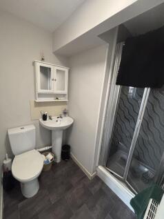 Bright and clean bathroom featuring a toilet, s...
