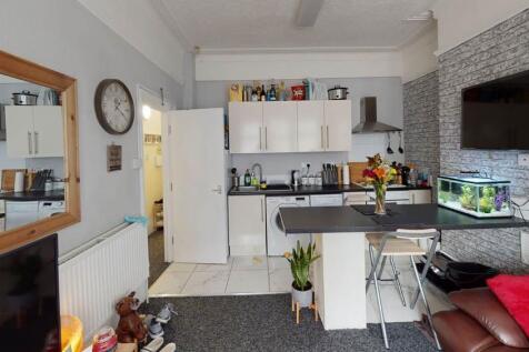 A bright and modern living room featuring conte...