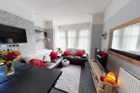 A spacious and modern living room filled with n...