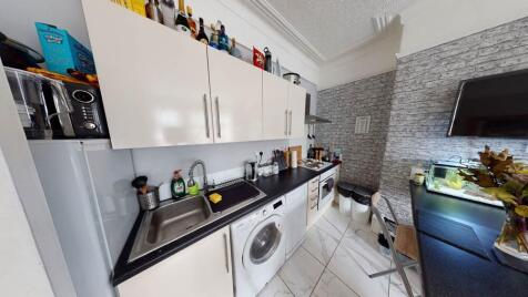 A modern, well-maintained kitchen area with amp...