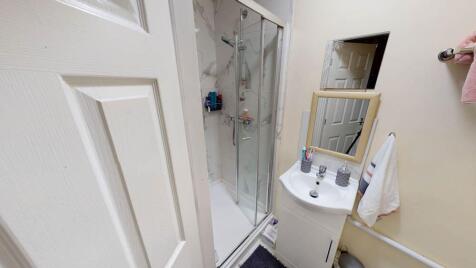 A clean and functional bathroom featuring a gla...