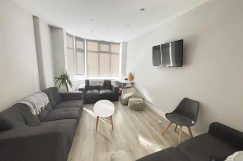 Bright and modern living room featuring ample n...