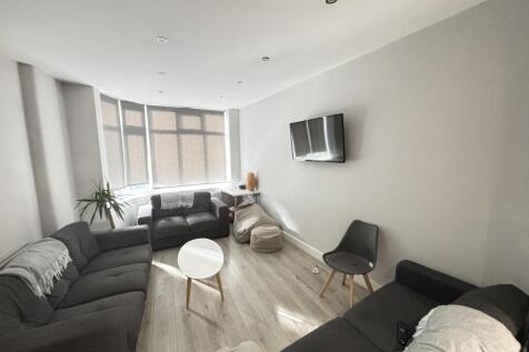 A spacious, well-lit living room with a contemp...