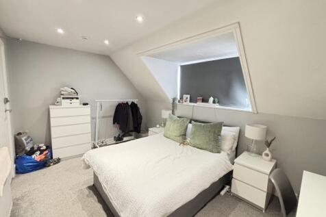 Bright and spacious master bedroom featuring a ...
