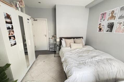 A bright and spacious master bedroom featuring ...