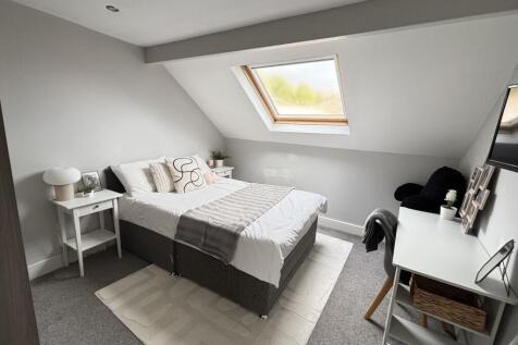 A bright and neatly maintained bedroom with a c...