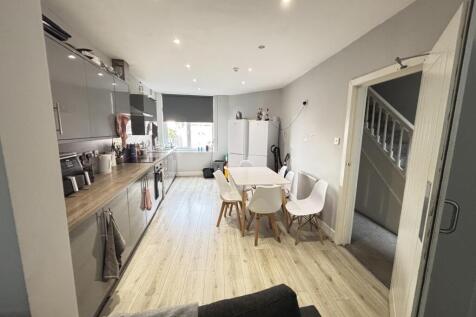 A spacious and modern living room filled with n...