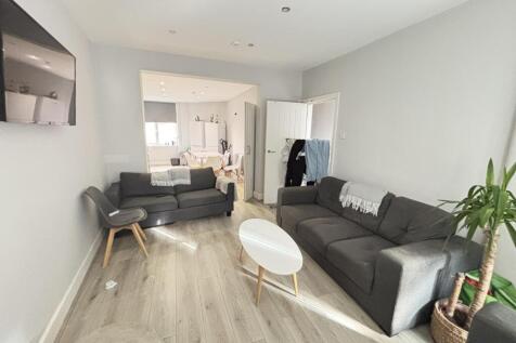 Bright and modern living room with ample natura...