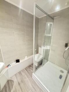 A bright and clean bathroom featuring a spaciou...