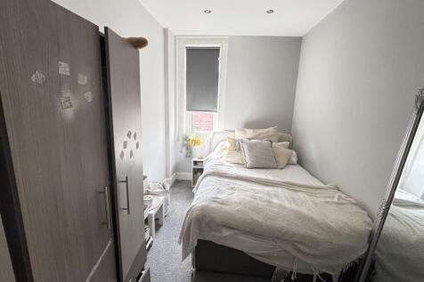 A cozy bedroom featuring a double bed and a war...