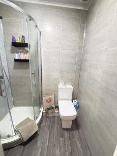A modern, neatly maintained bathroom with clean...