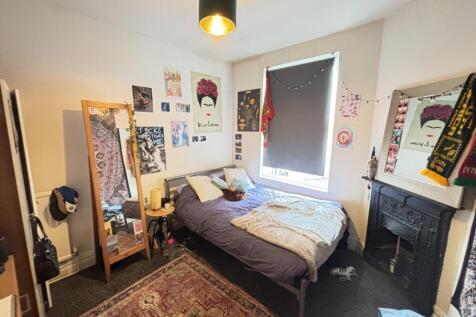 A spacious and cozy master bedroom featuring a ...