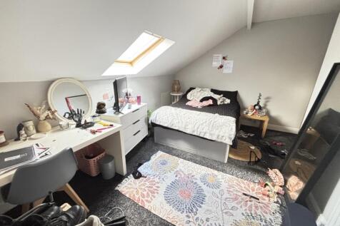 A bright and well-maintained bedroom featuring ...