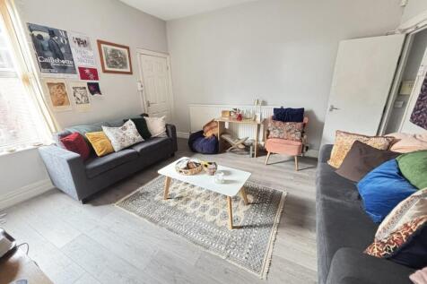 A bright and welcoming living room featuring co...