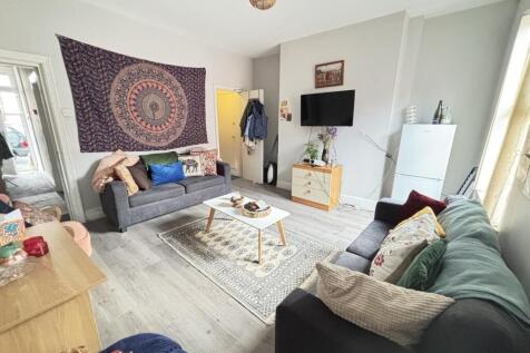 A welcoming, well-lit living room with modern f...