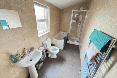 A well-maintained bathroom featuring a bathtub,...