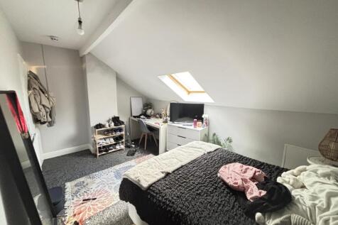 A cozy bedroom with a large double bed, natural...