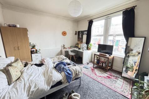 A cozy living room featuring a comfortable sofa...