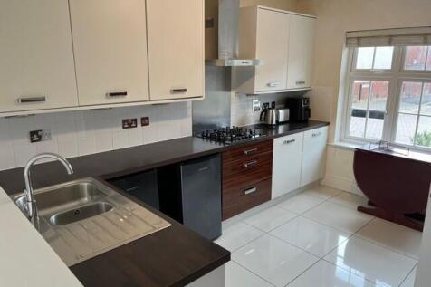 Bright and modern kitchen with ample cabinetry,...