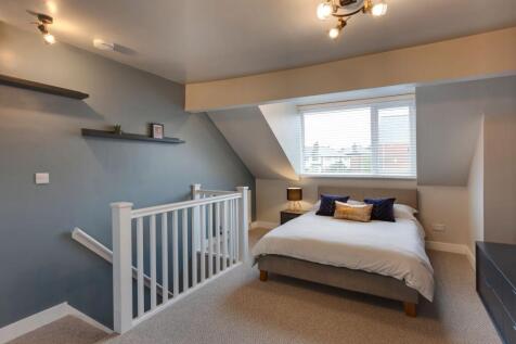 Bright and spacious master bedroom featuring a ...
