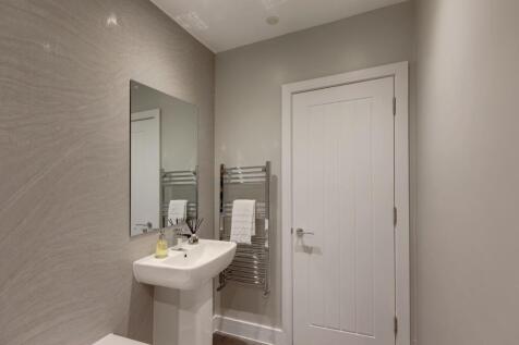 Modern and tidy bathroom featuring a sleek sink...