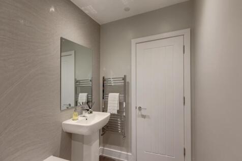 Contemporary bathroom with a pedestal sink, lar...